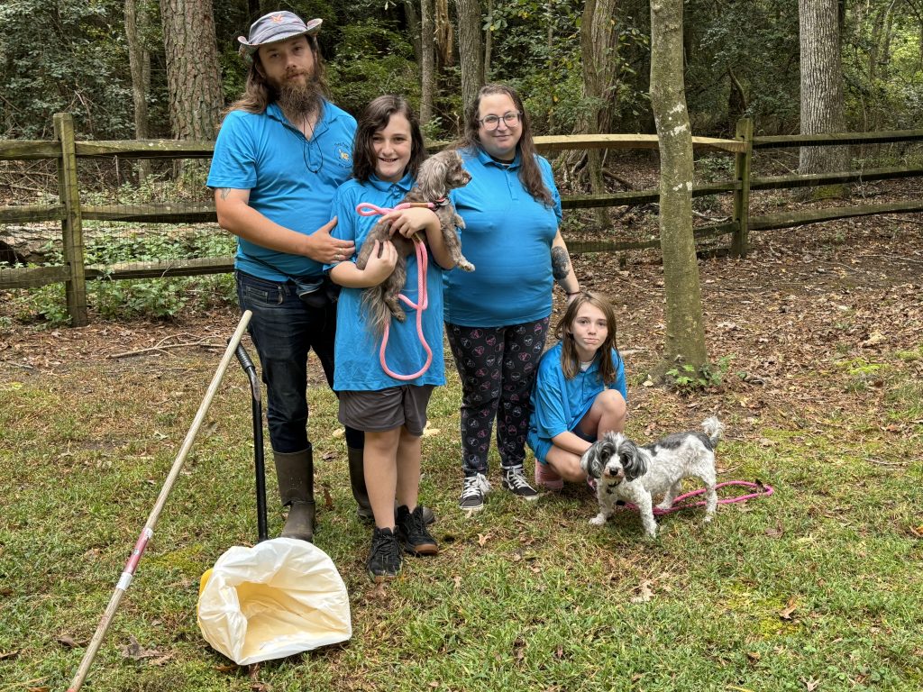 A family and their dogs enjoying time outside